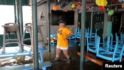 Robyn Iacona-Hilbert walks through her flooded business after Hurricane Barry in Mandeville, La., July 13, 2019. 
