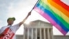 Carlos McKnight of Washington, waves a flag in support of gay marriage outside of the Supreme Court in Washington, D.C., June 26, 2015. 