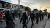 FILE - Riot police walk the streets after a demonstration against the government of President Miguel Diaz-Canel in Arroyo Naranjo Municipality, Havana, July 12, 2021. 