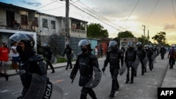 FILE - Riot police walk the streets after a demonstration against the government of President Miguel Diaz-Canel in Arroyo Naranjo Municipality, Havana, July 12, 2021. 