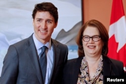 FILE - Newly appointed president of the Treasury Board Jane Philpott poses for a photo with Prime Minister Justin Trudeau during Trudeau's cabinet shuffle, in Ottawa, Ontario, Canada, Jan. 14, 2019.