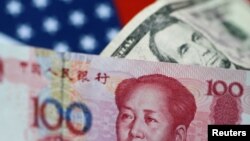 FILE - U.S. Dollar and China Yuan notes are seen in this picture illustration.