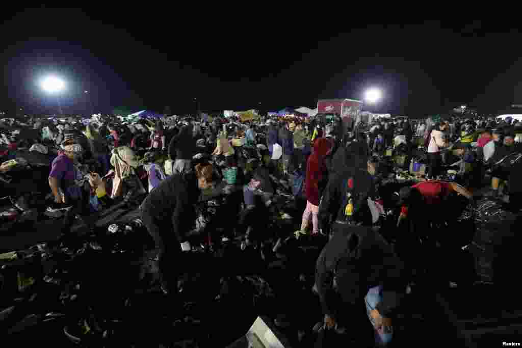 People affected by the Eaton Fire look for donated clothing at a distribution center at Santa Anita Park in Arcadia, California, Jan. 11, 2025. 