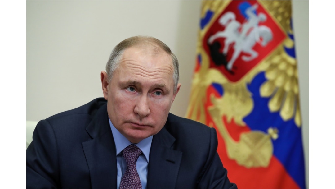 FILE - Russian President Vladimir Putin chairs a meeting with government members via a videoconference at Novo-Ogaryovo state residence outside Moscow, Russia, Jan. 28, 2021.