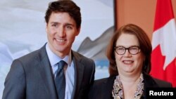 FILE - Newly appointed president of the Treasury Board Jane Philpott poses for a photo with Prime Minister Justin Trudeau during Trudeau's cabinet shuffle, in Ottawa, Ontario, Canada, Jan. 14, 2019. 