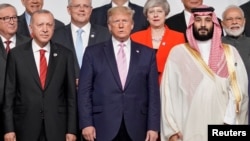 FILE - Turkey's President Tayyip Erdogan, US President Donald Trump and Saudi Arabia's Crown Prince Mohammed bin Salman at a family photo session for leaders and attendees at the G-20 leaders summit in Osaka, Japan, June 28, 2019. 
