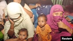 FILE - Pakistani female prisoners sit in a cell, along with their children, at Central Jail in Rawalpindi, near Islamabad, July 8, 2006.