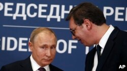 FILE - Russian President Vladimir Putin, left, speaks with Serbian President Aleksandar Vucic during a joint news conference in Belgrade, Serbia, Jan. 17, 2019. 