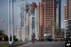 A participant of the Pyongyang marathon runs down Mirae Scientist Street, April 9, 2017, in Pyongyang, North Korea.