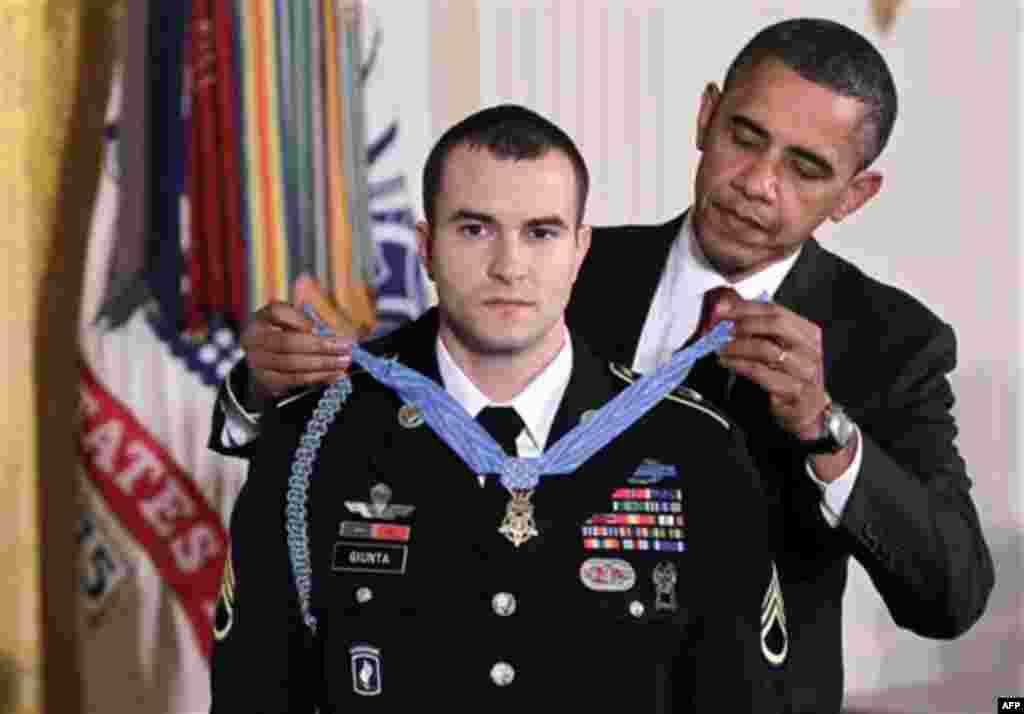 President Barack Obama presents the Medal of Honor to Staff Sgt. Salvatore Giunta, who rescued two members of his squad in October 2007 while fighting in the war in Afghanistan, Tuesday, Nov. 16, 2010, at the White House in Washington. (AP Photo/J. Scott