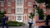 FLE- A University of Connecticut student waits for the traffic light to change outside a dormitory building on the campus in Storrs, Conn., Sept. 18, 2015.