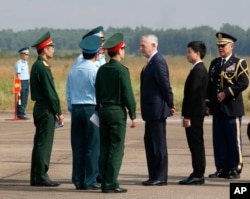 U.S. Defense Secretary Jim Mattis, third right, talks with Vietnamese military officials while he visits Bien Hoa air base in Bien Hoa, outside Ho Chi Minh City, Vietnam, Oct. 17, 2018. (Kham/Pool Photo via AP)