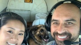 Pilot Eduard Seitan and his fiancee, Debbie, sit in the cockpit of his plane. They are preparing to deliver a rescue dog to its new home.