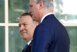 FILE - Secretary of State Mike Pompeo, back left, and National Security Adviser Robert O'Brien head to the Oval Office of the White House, in Washington, Nov. 25, 2019.