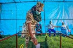 FILE - In this Sept. 9, 2020, photo, a member of the Tigray special forces casts his vote in a local election in the regional capital, Mekele, in the Tigray region of Ethiopia.