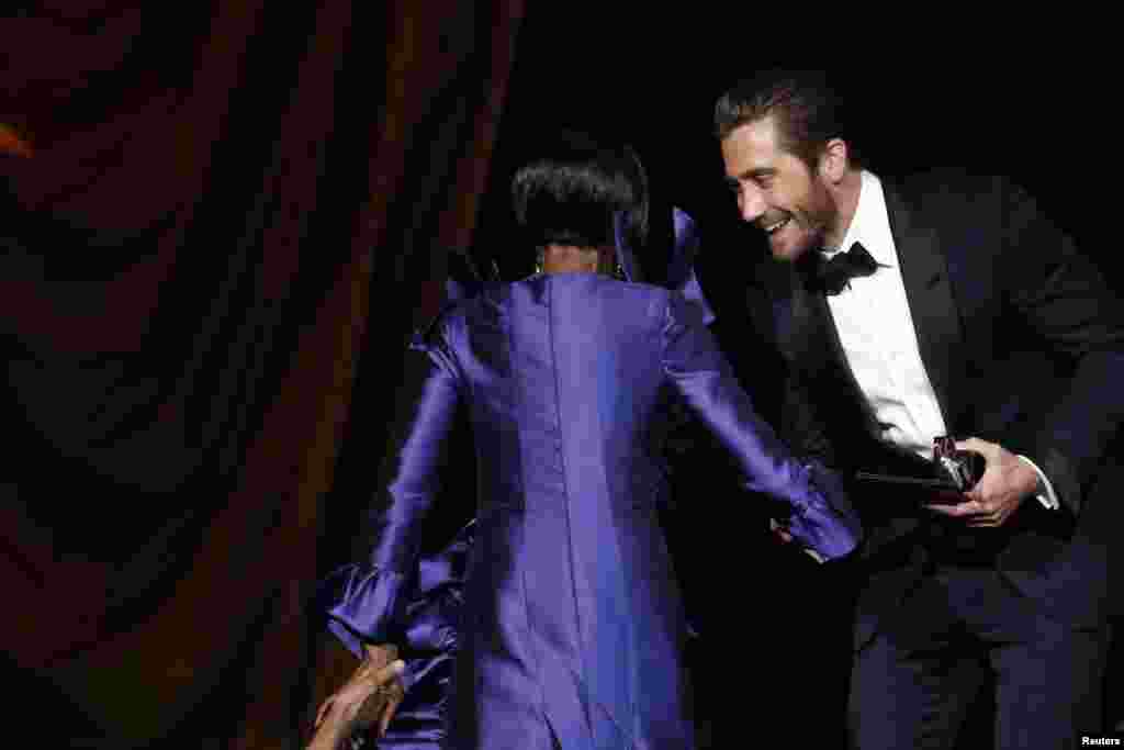 Actor Jake Gyllenhaal helps actress Cicely Tyson onto the stage after she was awarded Best Performance by an Actress in a Leading Role in a Play for "The Trip to Bountiful" during the Tony Awards in New York, June 9, 2013.