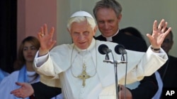 Pope Benedict XVI gestures to believers after visiting the sanctuary of the Virgin of Charity of El Cobre in El Cobre village, Cuba, March 27, 2012.