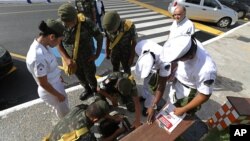 FILE - Soldiers conduct inspection in a school during a national day of awareness to eradicate the Aedes aegypti mosquito, in Brasilia, Brazil, Feb. 19, 2016. 