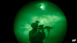 A U.S soldier patrols at night in Khost province, Afghanistan, seen through night vision equipment. About 400,000 veterans had a PTSD diagnosis in 2013, according to the Veterans Affairs health system.