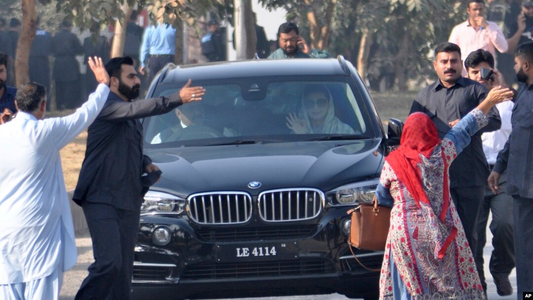 Maryam Nawaz, daughter of former Prime Minister Nawaz Sharif, right front passenger in vehicle, waves upon her arrival at an accountability court in Islamabad, Pakistan, Friday, Oct. 13, 2017. 