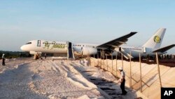 A Fly Jamaica Boeing 757-200 aircraft, which overshot the runway, sits at the northeastern takeoff end of the runway at the Cheddi Jagan International Airport, in Georgetown, Guyana, Nov. 9, 2018. 