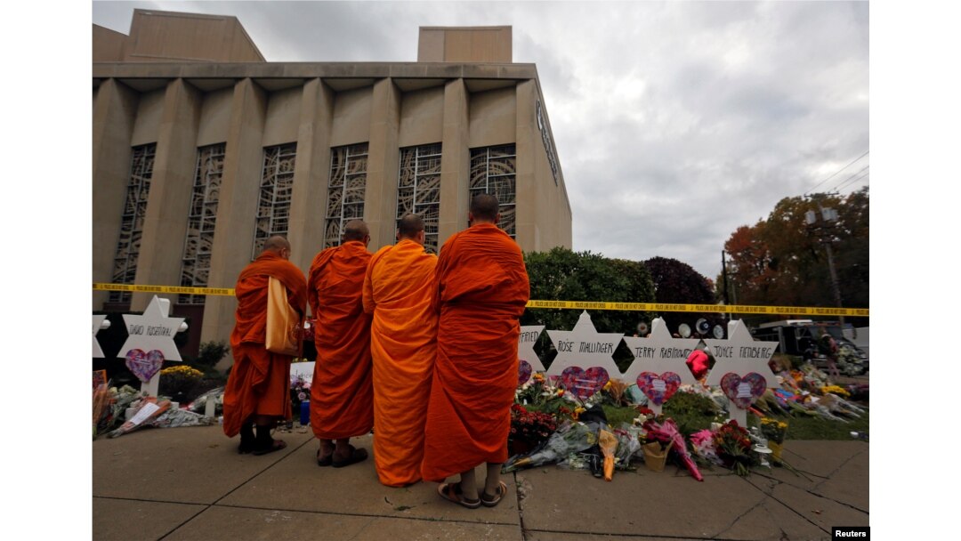 FILE - Monks pay their respects at a makeshift memorial outside the Tree of Life synagogue following Saturday's shooting at the synagogue in Pittsburgh, Penn., Oct. 29, 2018.
