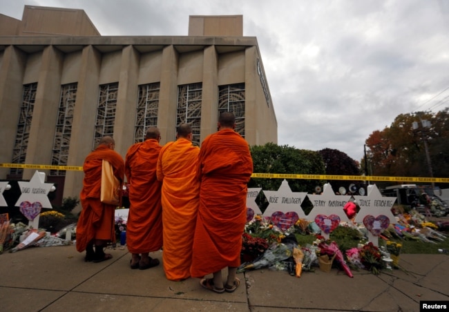 FILE - Monks pay their respects at a makeshift memorial outside the Tree of Life synagogue following Saturday's shooting at the synagogue in Pittsburgh, Penn., Oct. 29, 2018.
