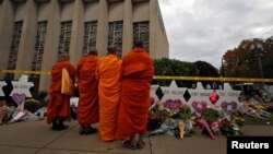 Monks pay their respects at a makeshift memorial outside the Tree of Life synagogue following Saturday's shooting at the synagogue in Pittsburgh, Penn., Oct. 29, 2018. 