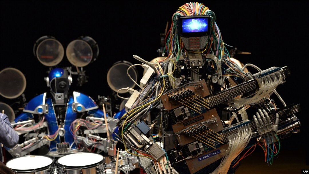 Robot guitarist "Mach" and robot drummer "Ashura" (L), members of a robot rock band "Z-Machines", perform music during the two day art and technology event "Maker Faire Tokyo."