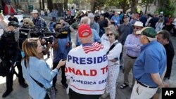 A supporter of President Donald Trump, center, argues opposing views during a free speech rally, Aug. 27, 2017, in Berkeley, California. 