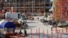 FILE - Migrant laborers work at a construction site in Doha, Qatar, March 26, 2016. 