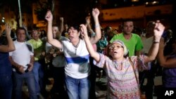 Opposition supporters celebrates the closing of a polling station during congressional elections in Caracas, Venezuela, Sunday, Dec. 6, 2015.