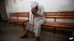 FILE - An elderly man waits to be treated for a suspected cholera infection at a hospital in Sana'a, Yemen, July 12, 2017.