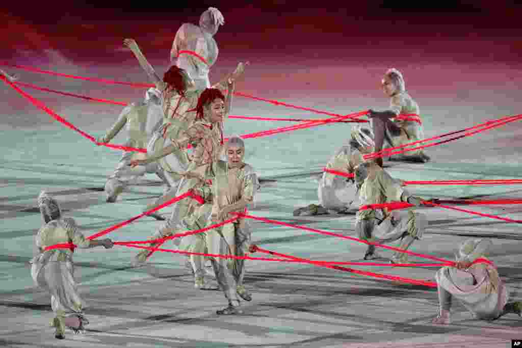 Dancers perform during the opening ceremony in the Olympic Stadium at the 2020 Summer Olympics, July 23, 2021, in Tokyo, Japan.