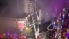 This screengrab taken on July 18, 2024 from a UGC video footage shot on July 17 shows firefighters extinguishing a fire tearing through a shopping centre in Zigong in China's southwestern Sichuan province.