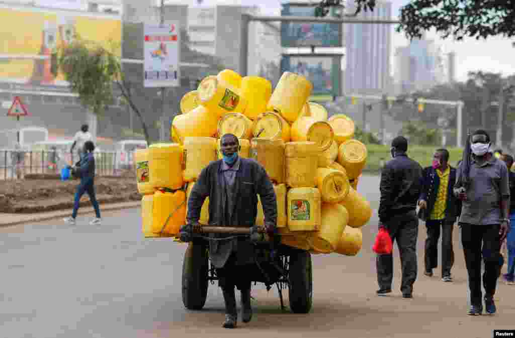 A man pulls a handcart with jerrycans in downtown Nairobi, Kenya.