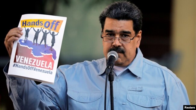 FILE - Venezuela's President Nicolas Maduro attends a gathering in support of his government in Caracas, Venezuela, Feb. 7, 2019.