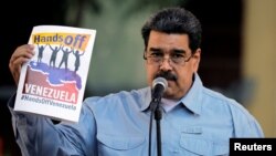 FILE - Venezuela's President Nicolas Maduro attends a gathering in support of his government in Caracas, Venezuela, Feb. 7, 2019. 