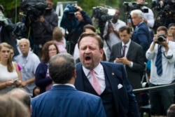 FILE - Conservative radio host Sebastian Gorka yells at White House correspondent for Playboy magazine Brian Karem after President Donald Trump spoke about the 2020 census in the Rose Garden of the White House, in Washington, July 11, 2019.