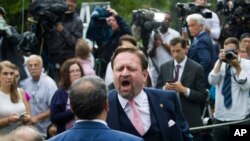 FILE - Conservative radio host Sebastian Gorka yells at White House correspondent for Playboy magazine Brian Karem after President Donald Trump spoke about the 2020 census in the Rose Garden of the White House, in Washington, July 11, 2019.