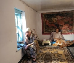 Aziz Isa Elkun’s mother talks to him by telephone in Xinjiang, China, in "An Unanswered Telephone Call." (Courtesy Aziz Isa Elkun)