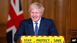 Britain's Prime Minister Boris Johnson speaks during a media briefing on COVID-19, in Downing Street, London, Jan. 15, 2021.