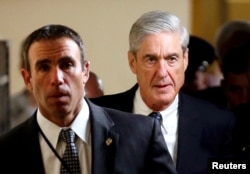 FILE : Special Counsel Robert Mueller (R) departs after briefing members of the U.S. Senate on his investigation into potential collusion between Russia and the Trump campaign on Capitol Hill in Washington, U.S., June 21, 2017.