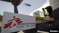 Workers unload emergency medical aid from Doctors Without Borders / Medecins Sans Frontieres at Yemen's Sana'a airport, April 13, 2015.