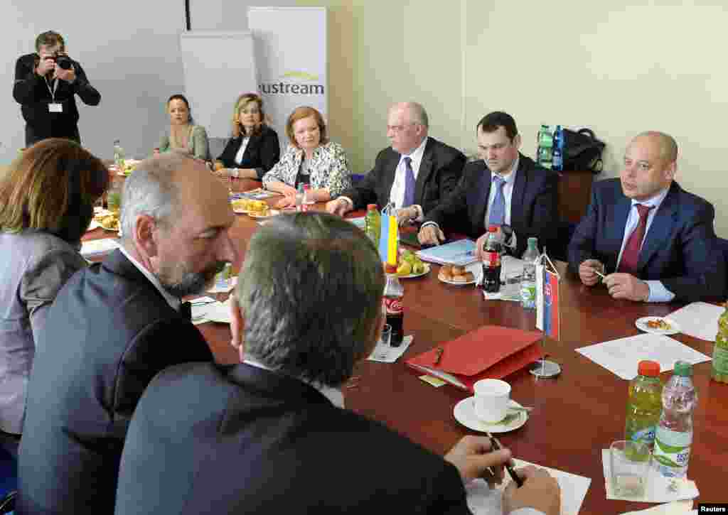 Ukraine's energy minister, Yuri Prodan (right), and Slovakia's economy minister, Tomas Malatinsky (2nd left), attend a meeting at a delivery station of pipeline operator Eustream in the eastern Slovak town of Velke Kapusany, near the border with Ukraine, April 15, 2014.