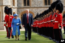 U.S. President Donald Trump with Queen Elizabeth II inspects the Guard of Honour at Windsor Castle in Windsor, England, July 13, 2018.