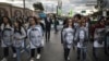 ARCHIVO - Manifestantes con fotos de activistas asesinados en Colombia protestan en Bogotá el 26 de julio de 2019.