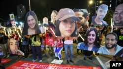 Protesters hold portraits of hostages held captive in Gaza by Palestinian militants during a Jan. 4, 2025, demonstration in Tel Aviv, Israel, calling for action to secure the hostages' release.