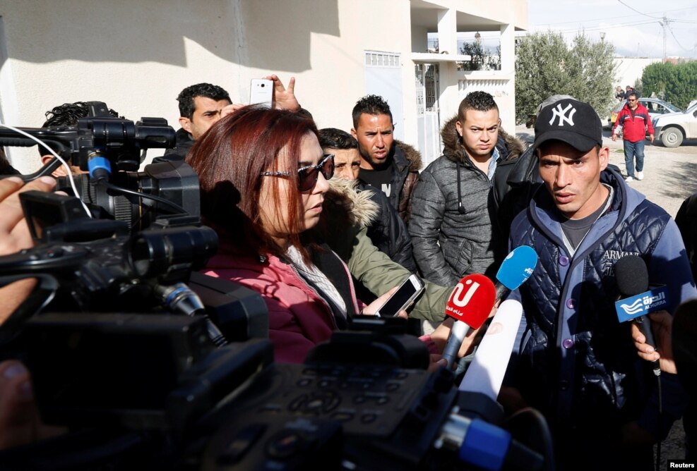 Walid, brother of suspect Anis Amri who was sought in connection with the truck attack on a Christmas market in Berlin, speaks to members of the media near their family home in Oueslatia, Tunisia, Dec. 22, 2016.