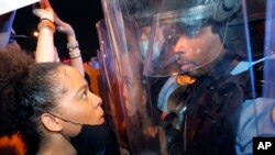 A protester and a police officer stare at one another on the Crescent City Connection bridge, which spans the Mississippi River in New Orleans, June 3, 2020, during a protest over the May 25 death of George Floyd.